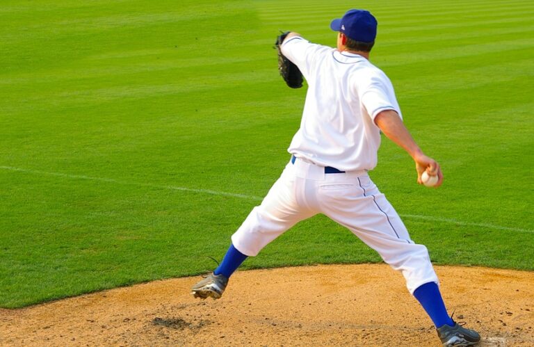 Pitcher winding up for a pitch on a baseball field