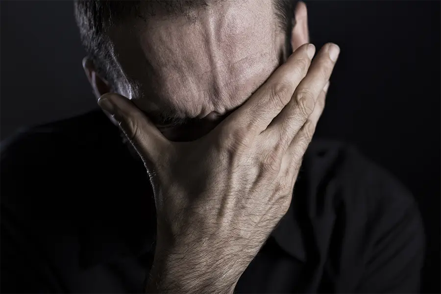 close up of depressed man in pain