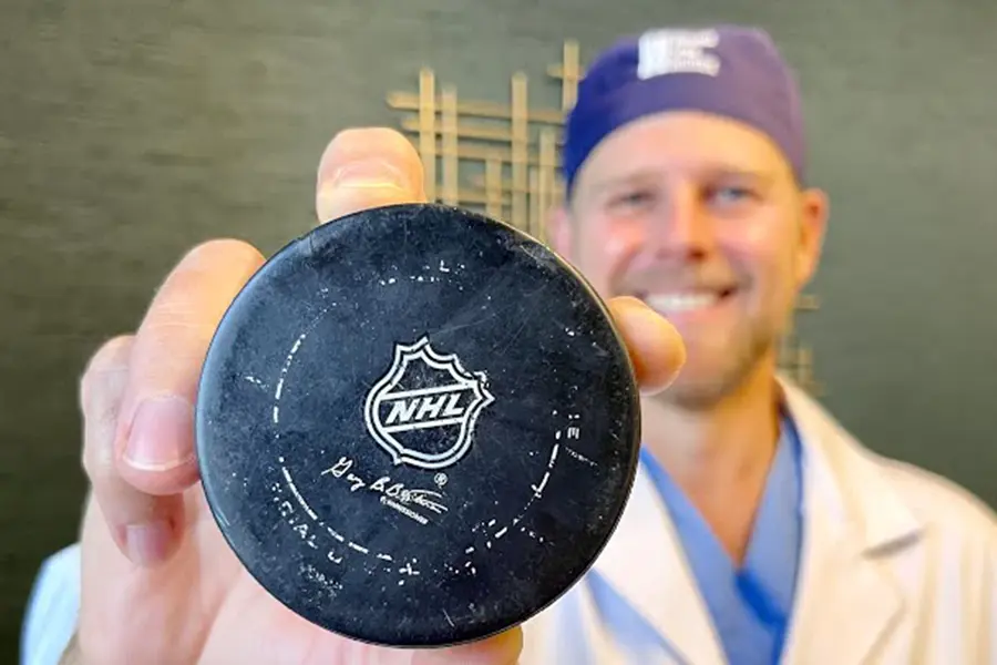 dr. good holding hockey puck