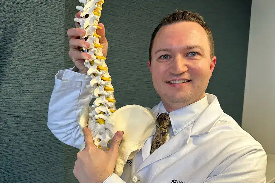 dr. kemp posing with spine