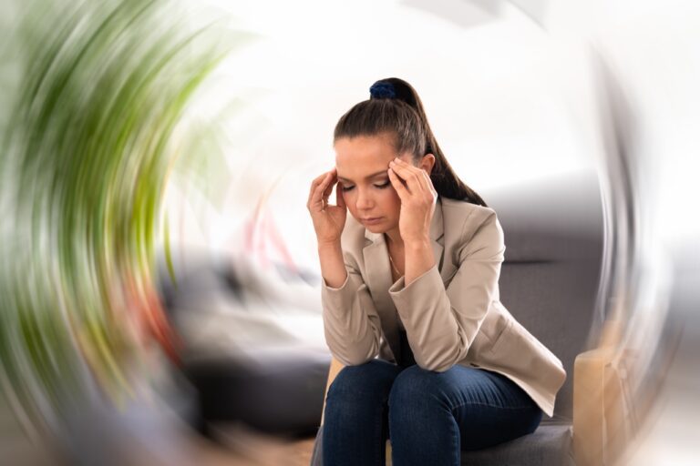 Woman sitting and feeling dizzy