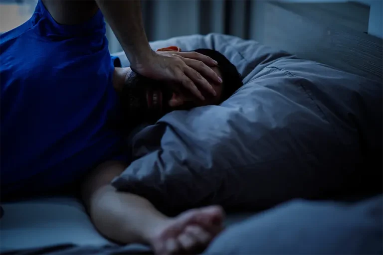 man touching his head with pain insomnia