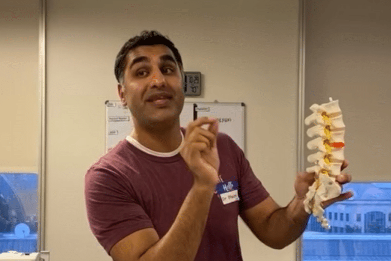 Dr. B holding spine and teaching