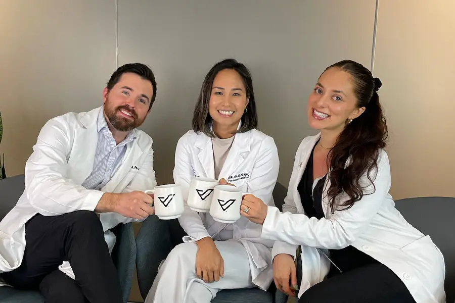 Ian, Thao, and Sam pose with mugs in their hands