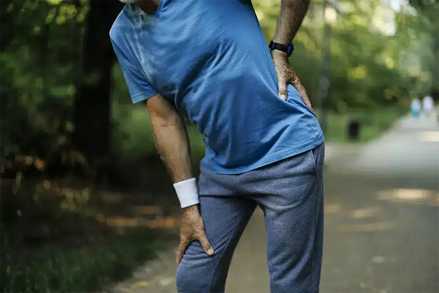 senior man runner with hip pain in the park