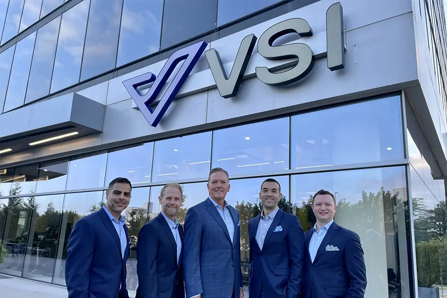 surgeons in front of the VSI sign