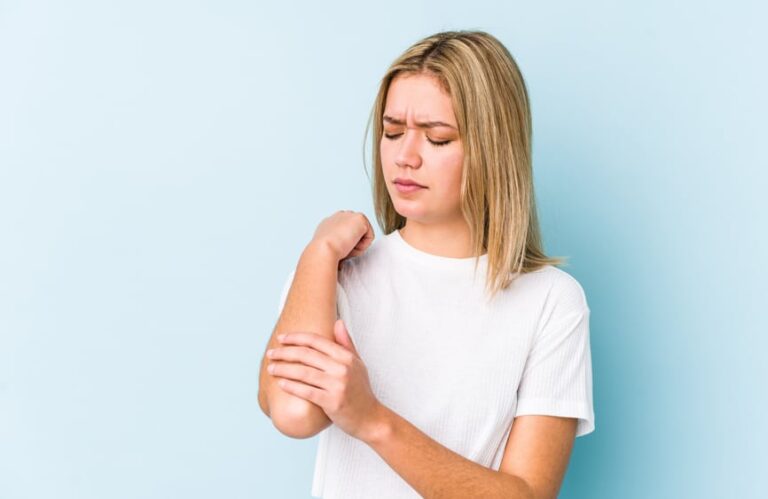 Woman gripping her elbow in pain