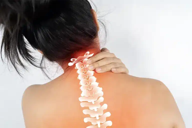 woman suffering from neck pain with view of cervical spine